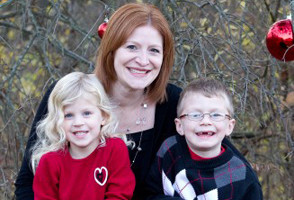 Kim DeAngelo smiles wide with her two children.