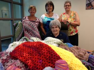 The ladies of Yarn Club are busy making shawls to give to donor families.